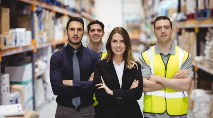 Portrait of warehouse manager and workers in warehouse