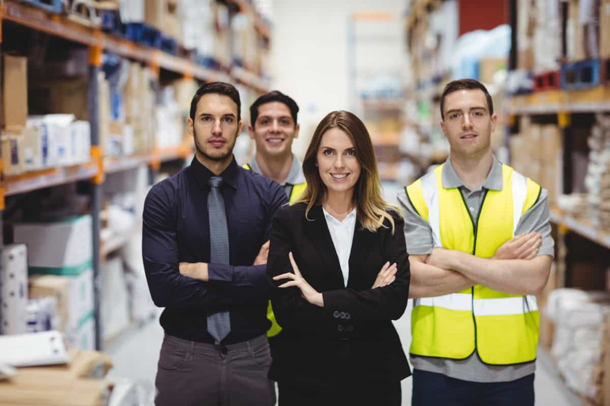 Portrait of warehouse manager and workers in warehouse